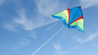 kite flying through the wind