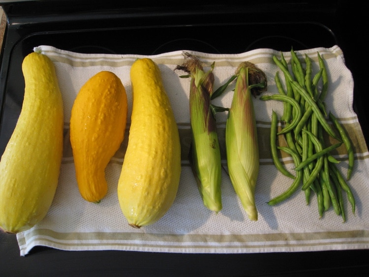 Squash, beans, and corn on a towel