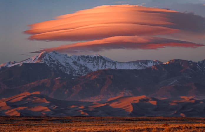 warm pink cloud over mountains