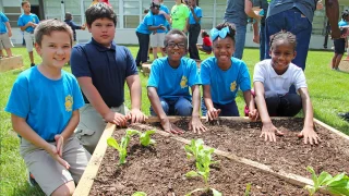group of kids planting their garden