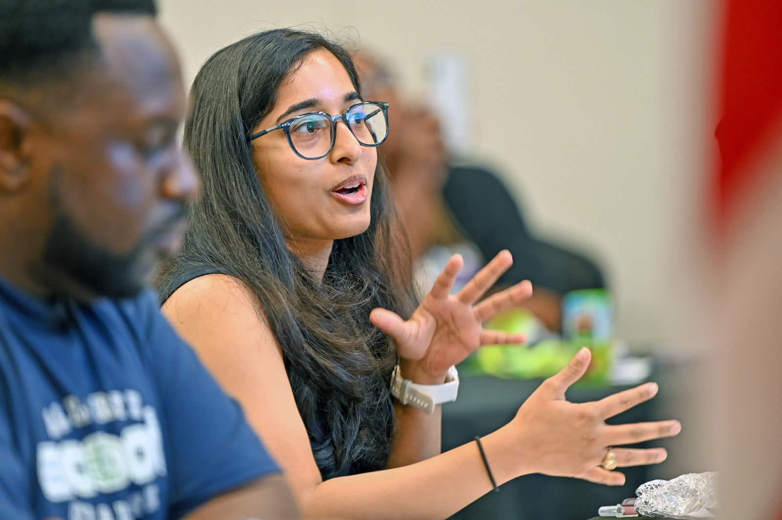 Riya Santra, Packaged Application Specialist at Accenture, asking follow-up questions during the judging round.