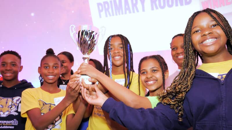 The Green Clan from Wadsworth Magnet School for High Achievers holds their trophy proudly.