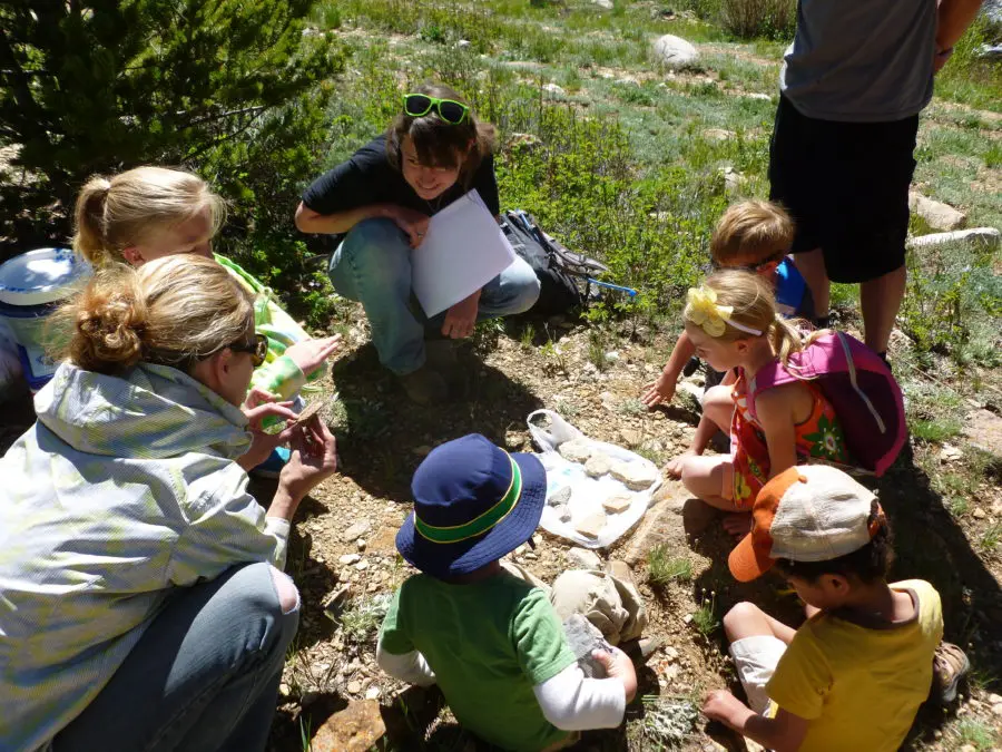 Young children learning about rocks in outdoor classroom