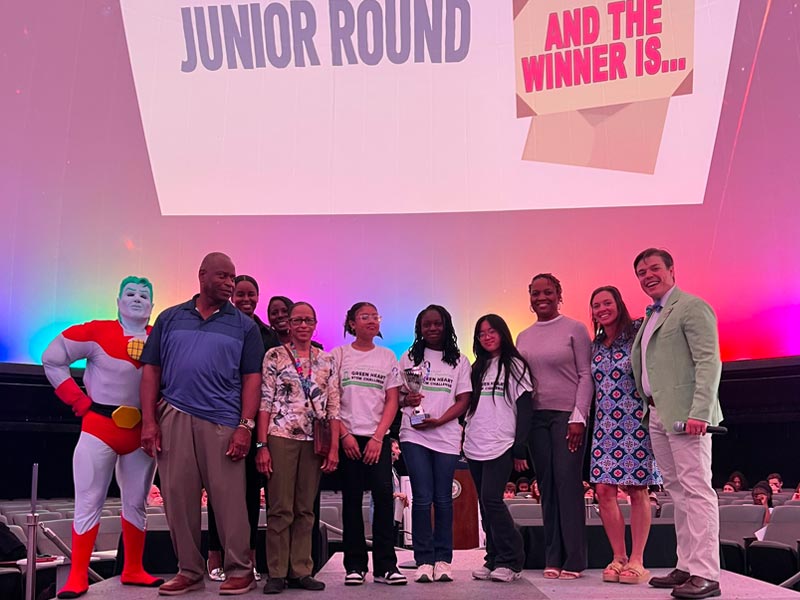 The BMS Green Victory Team accepts their 1st place trophy alongside Atlanta Judges