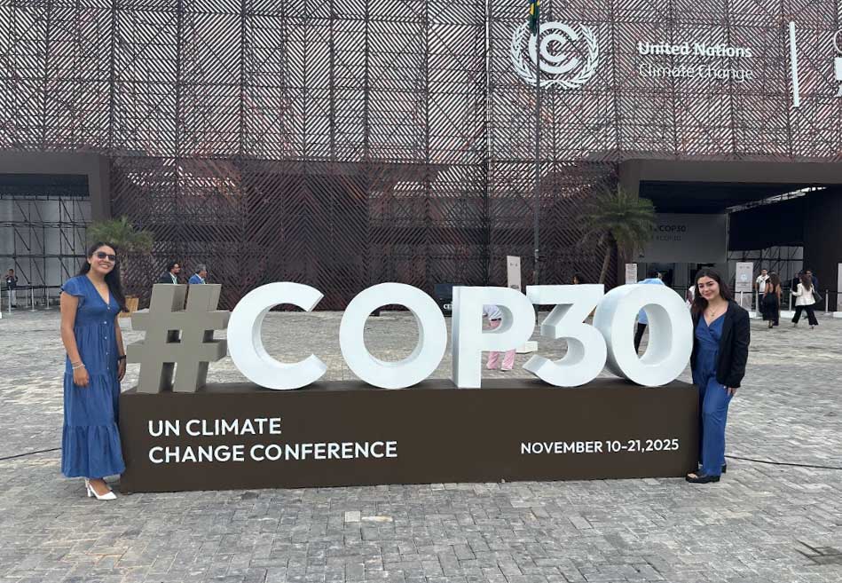 Mafer (left) and Natalia (right) pose at the entrance to COP30.