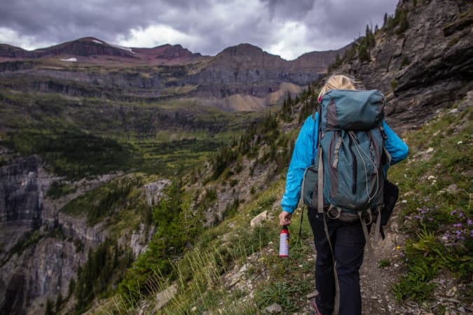 woman hiking through mountains