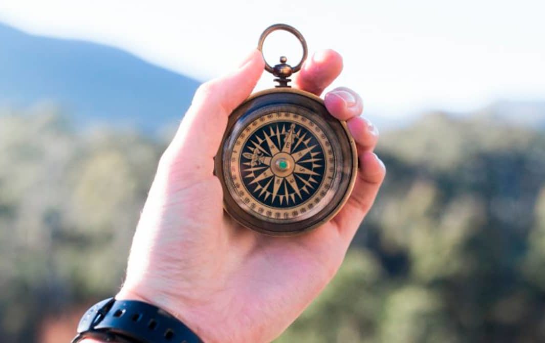 hand holding a compass