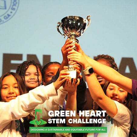 Youth holding a Green Heart STEM Challenge trophy
