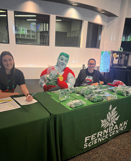 Team Planet welcomes students at the registration desk with Captain Planet.